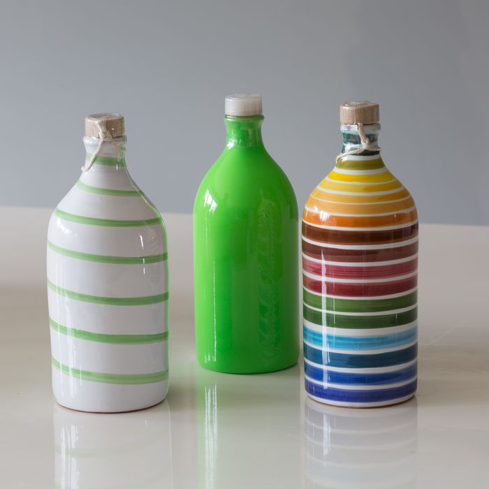 OLIVE OIL IN HAND MADE TERRACOTTA BOTTLES.